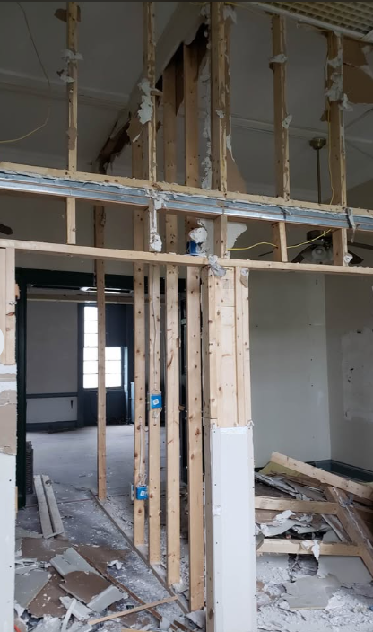 Exposed wood framing and steel track after interior partitions were demolished