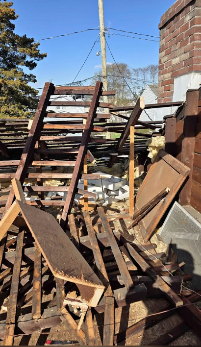 Stacked timber and demolition debris sorted in a yard for recycling and disposal