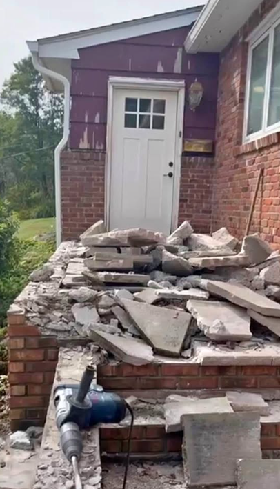 Front porch concrete broken up with a jackhammer leaving brick base and rubble ready for haul-away