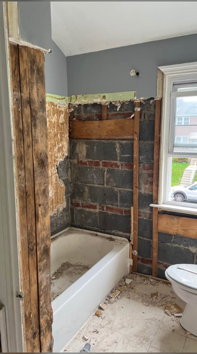 Bathtub surround stripped to block and brick after tile and wall removal