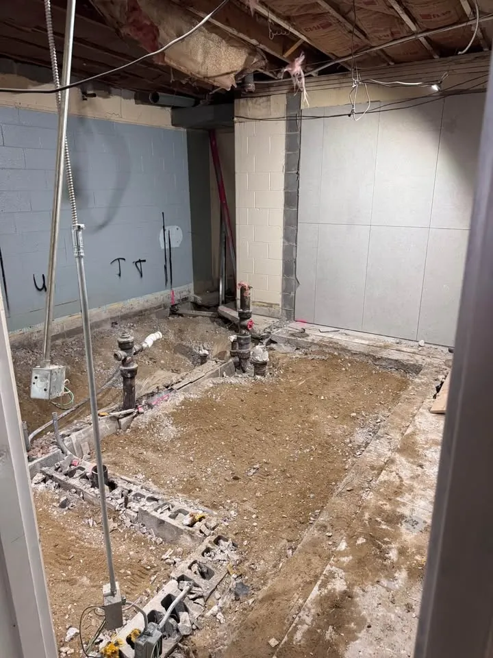 Basement floor cut and trenched along the block walls