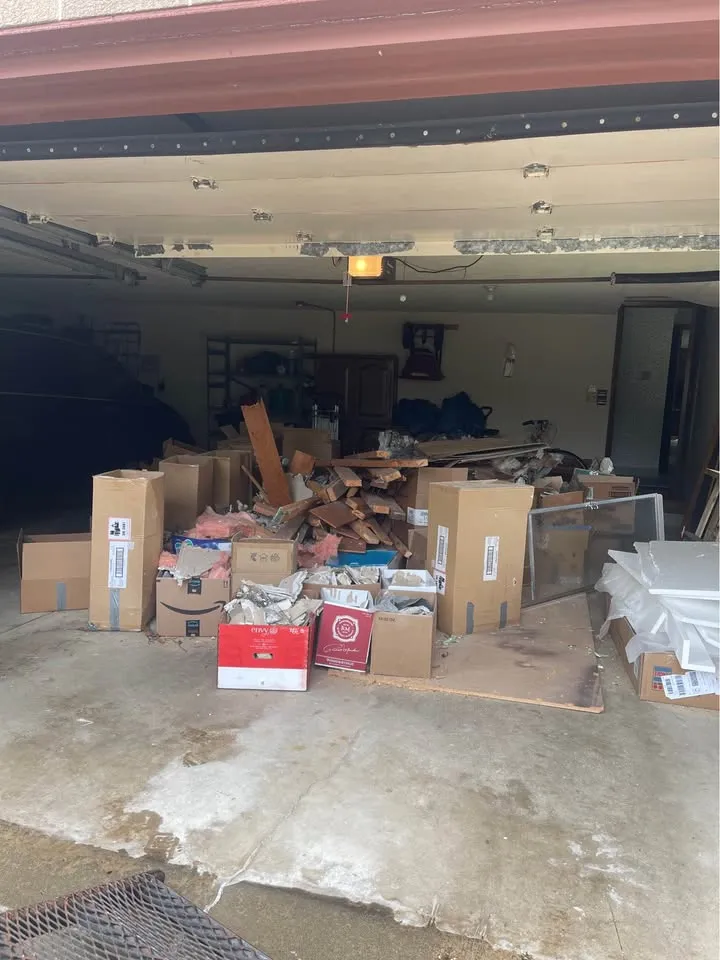 Garage stacked with boxes and discarded materials before a cleanout