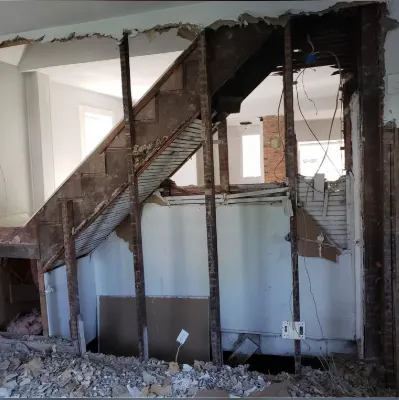 Staircase framing exposed after a load-bearing wall was opened up