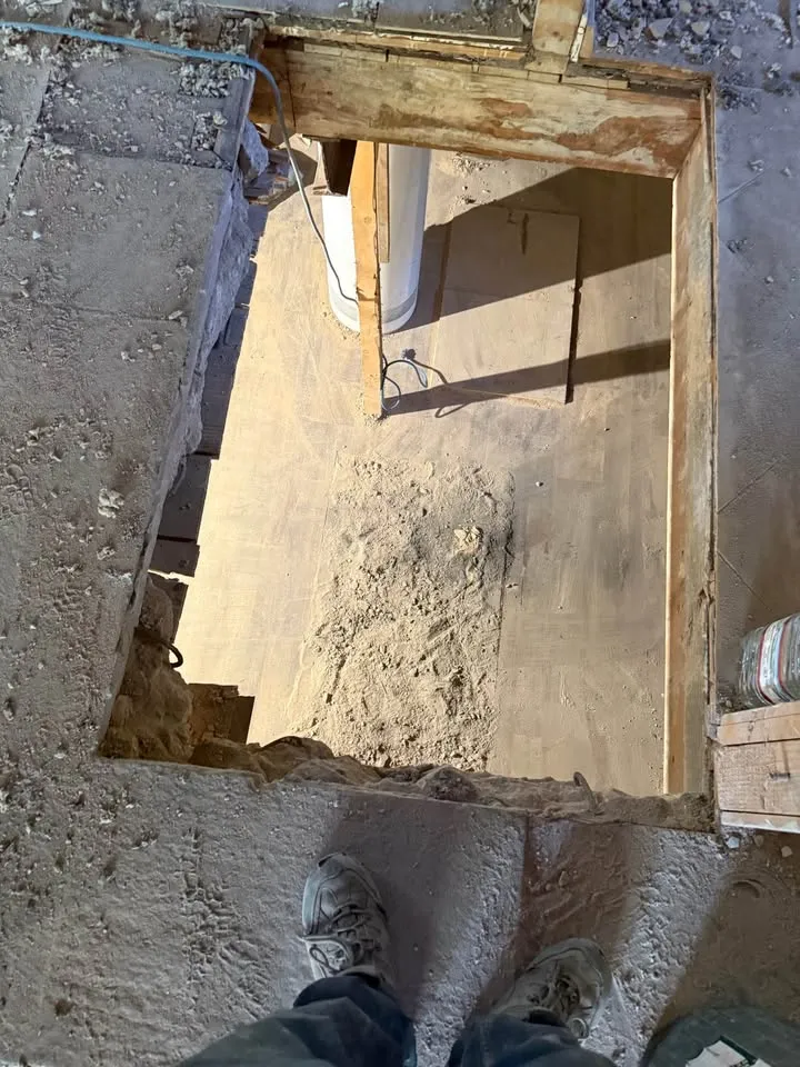 Framed floor opening cut around a removed chimney, seen from above